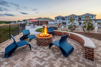 an outdoor patio with a fire pit and chairs at Anthem Apartment Homes and Luxury Rentals in Huntsville, AL